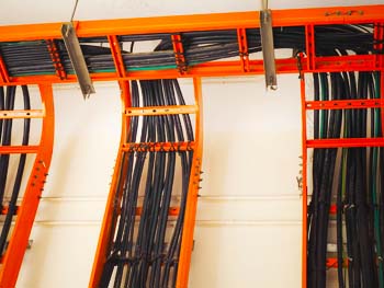 Structured Cabling system set-up within an orange metal rack